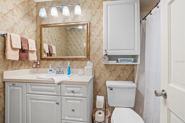 bathroom with toilet and vanity