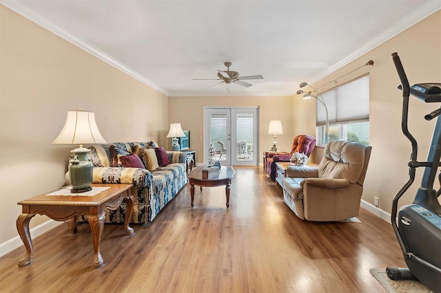 living room featuring hardwood / wood-style floors, ceiling fan, crown molding, and french doors