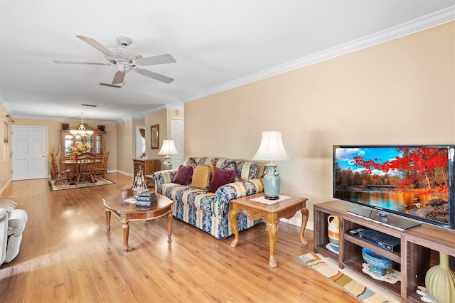 living room featuring ceiling fan, ornamental molding, and light hardwood / wood-style flooring