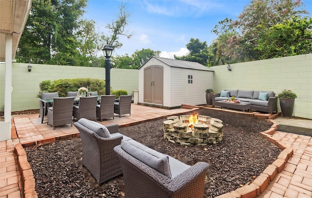 view of patio featuring a shed and an outdoor living space with a fire pit