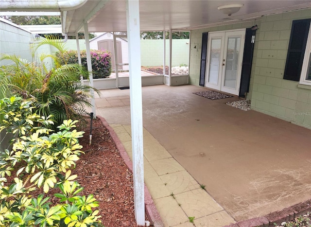 view of patio with a storage unit, fence, a ceiling fan, and an outbuilding