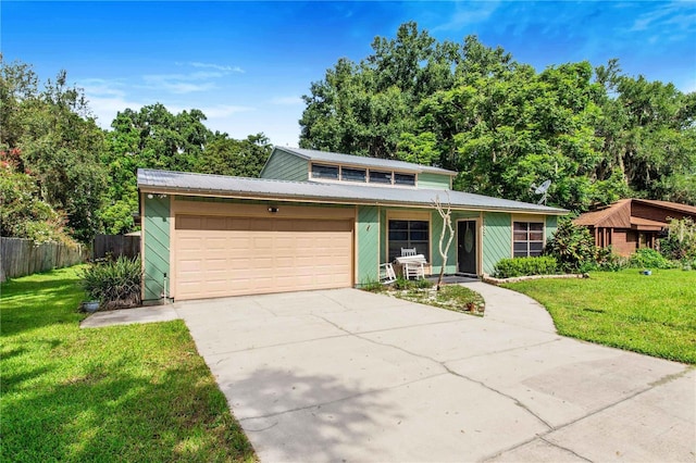 view of front property featuring a garage and a front lawn