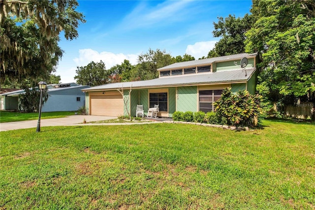 view of front of property with a garage and a front yard