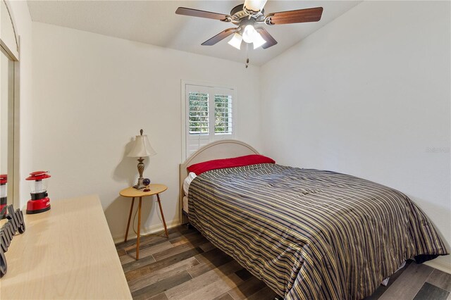 bedroom featuring ceiling fan and dark wood-type flooring