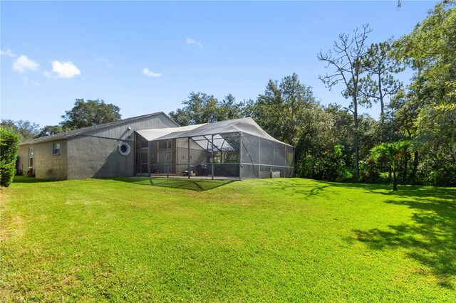 view of yard with glass enclosure