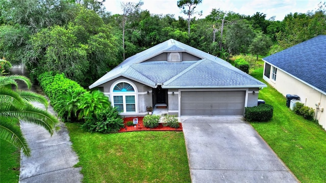 view of front of home with a garage and a front yard