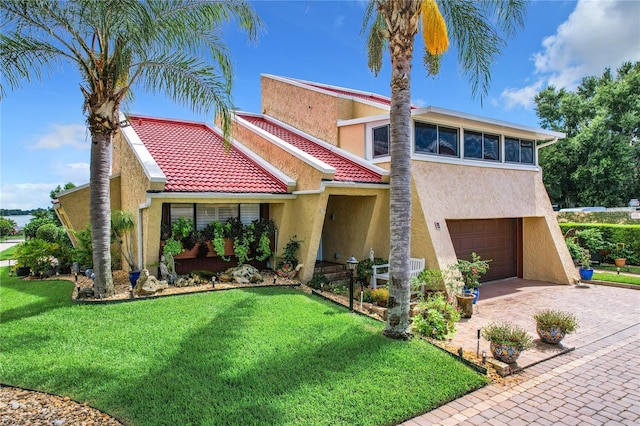 view of front of house with a front yard and a garage