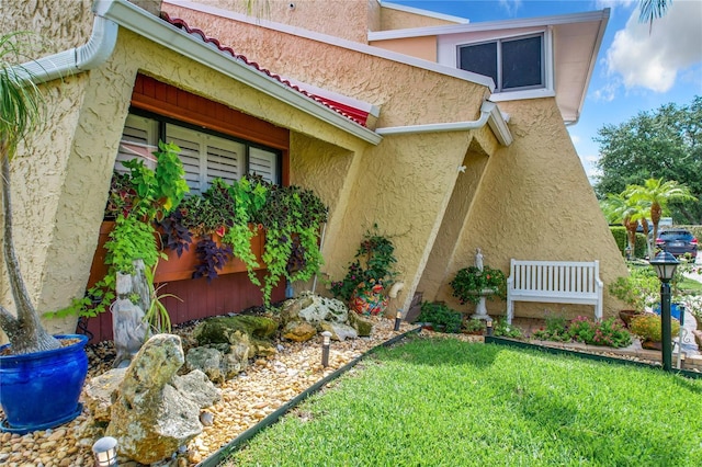 view of side of property with a lawn