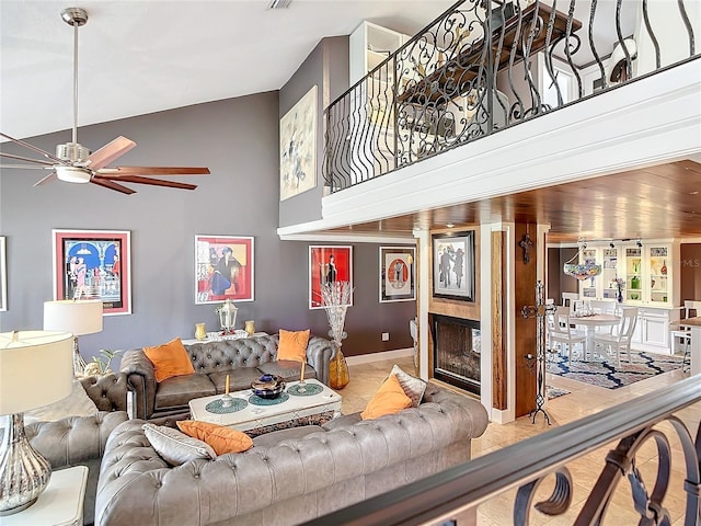 living room featuring ceiling fan and a towering ceiling