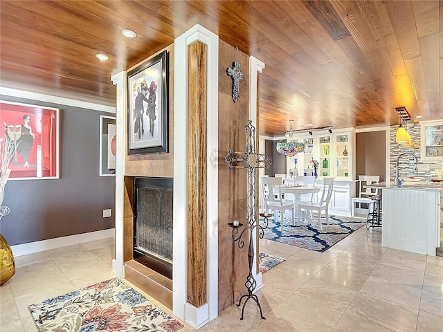 corridor featuring light tile patterned flooring and wood ceiling