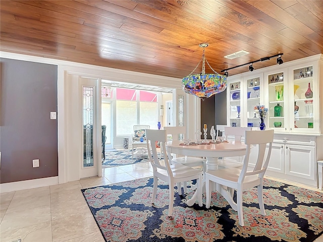 tiled dining room with rail lighting and wood ceiling