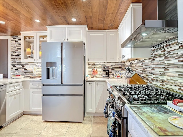 kitchen with white cabinetry, stainless steel appliances, and wall chimney exhaust hood