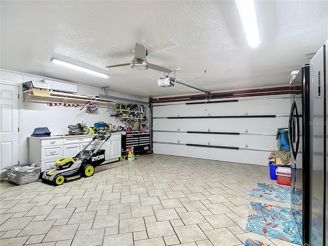 garage featuring a garage door opener, black refrigerator, and ceiling fan
