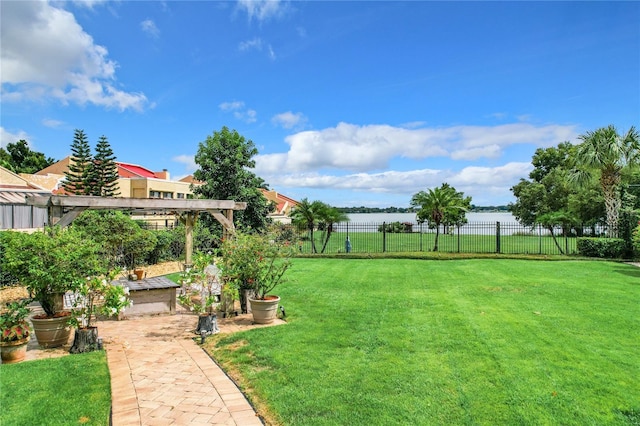 view of yard with a water view and a pergola