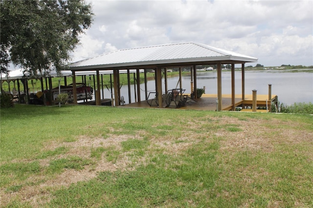 dock area featuring a lawn and a water view