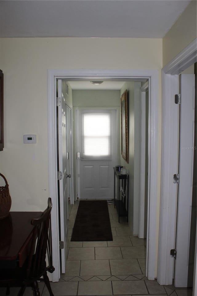 doorway featuring light tile patterned flooring