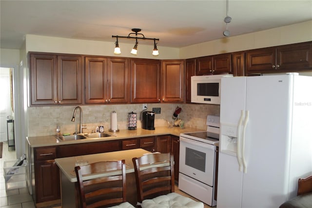 kitchen with light tile patterned floors, backsplash, white appliances, and sink