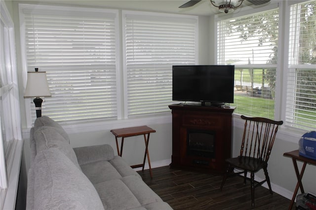 living room with dark hardwood / wood-style flooring and ceiling fan