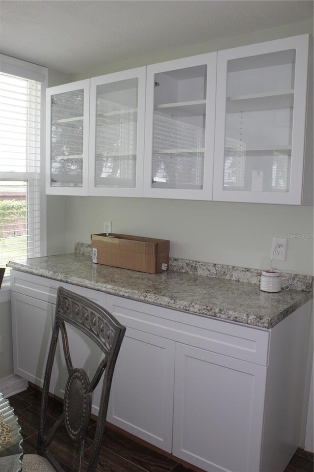 bar with white cabinetry, dark wood-type flooring, and a wealth of natural light