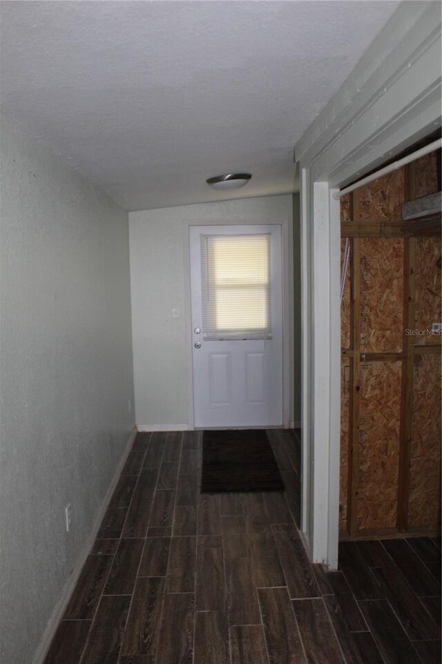 hallway with dark hardwood / wood-style flooring