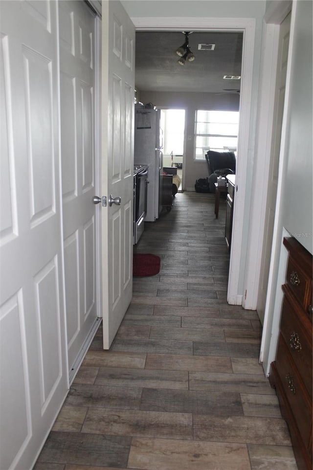 hallway with dark wood-type flooring