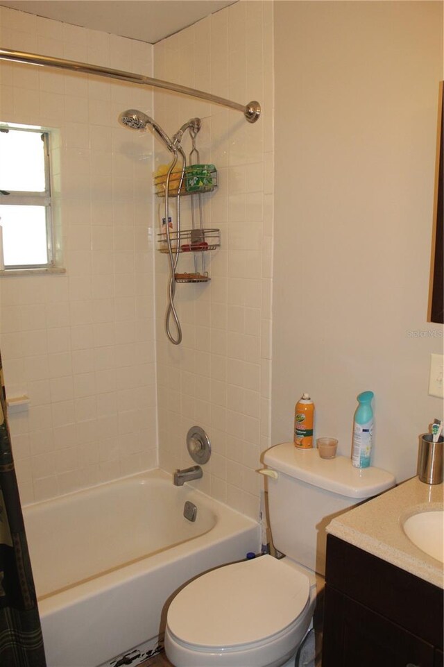 full bathroom featuring vanity, toilet, and shower / tub combo