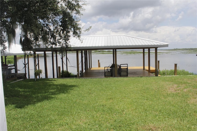 view of dock featuring a water view and a lawn