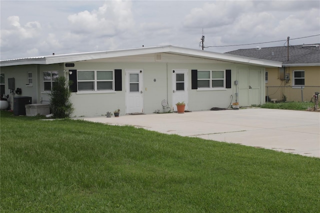 ranch-style house featuring central AC unit, a front lawn, and a patio