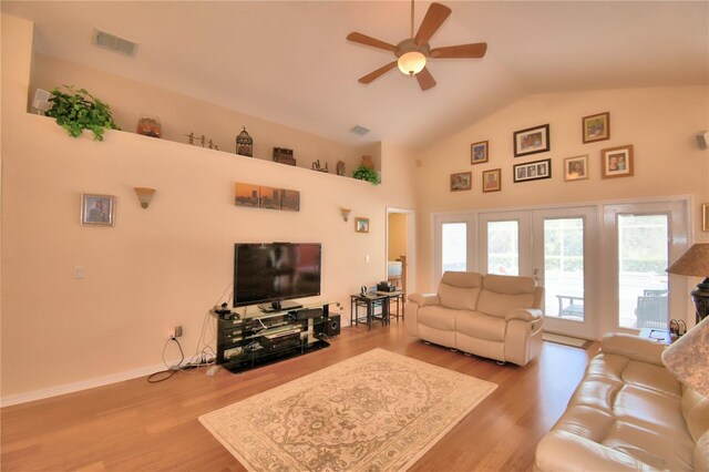 living room with ceiling fan, light wood-type flooring, and high vaulted ceiling