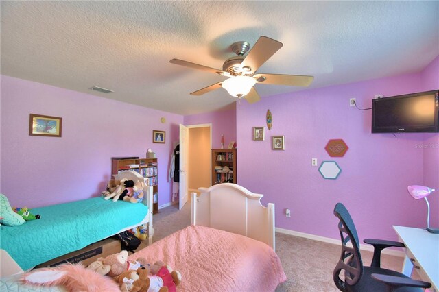 bedroom featuring a textured ceiling, ceiling fan, and carpet floors