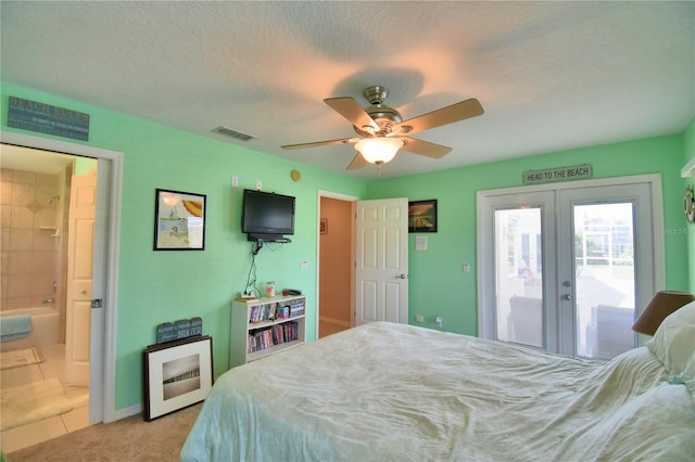 bedroom featuring a textured ceiling, ceiling fan, access to outside, french doors, and ensuite bath