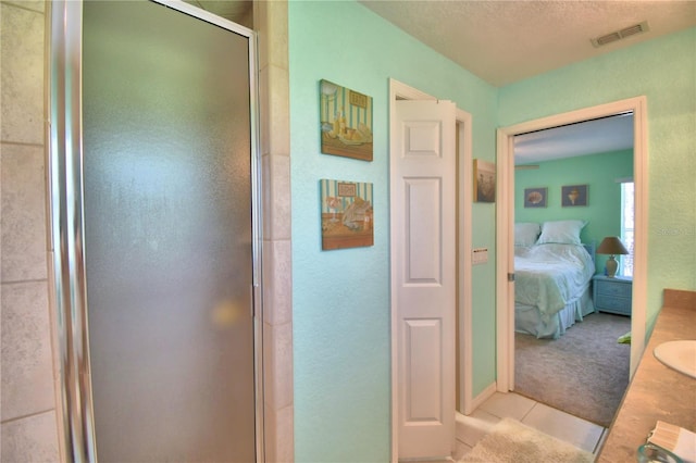 hallway featuring a textured ceiling and light colored carpet