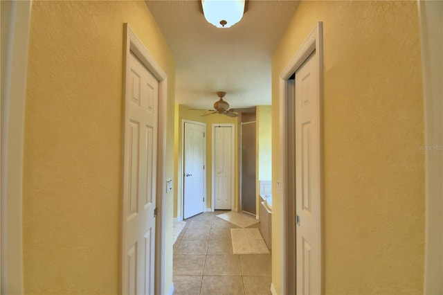 corridor with light tile patterned flooring