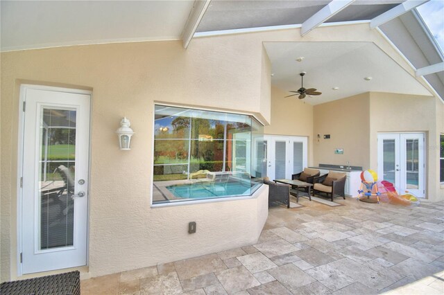 view of pool with ceiling fan, french doors, and a patio area