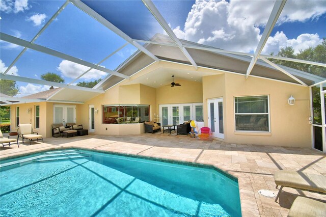 exterior space with glass enclosure, ceiling fan, and a patio