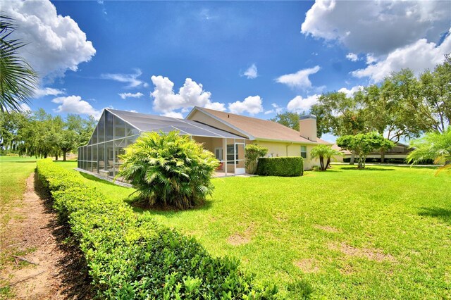 view of property exterior with a lanai and a yard