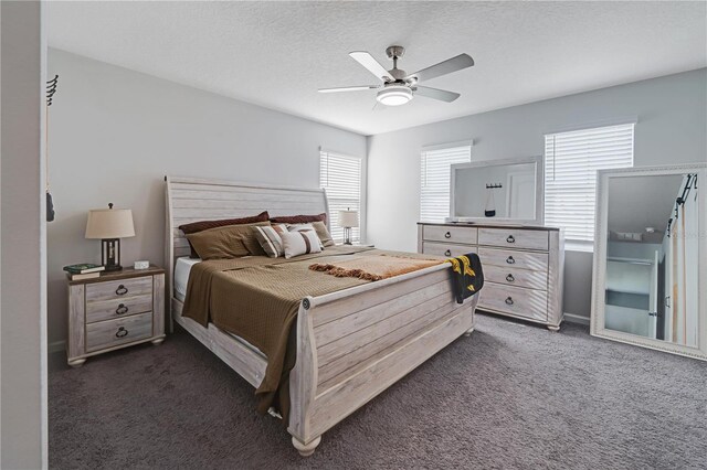 carpeted bedroom featuring a textured ceiling and ceiling fan