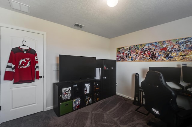 office area featuring dark colored carpet and a textured ceiling