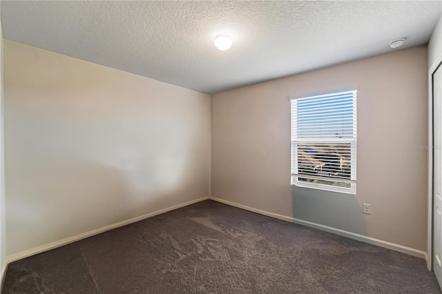 unfurnished room featuring carpet floors and a textured ceiling