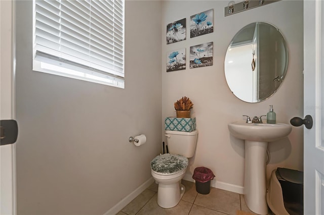 bathroom with toilet and tile patterned flooring