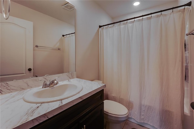 bathroom featuring vanity, tile patterned floors, and toilet