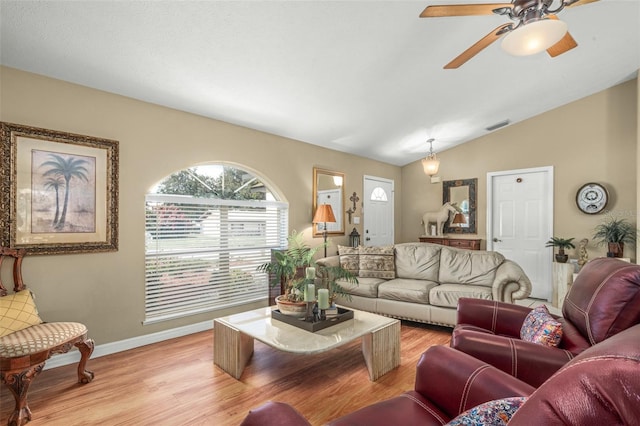 living room featuring light hardwood / wood-style floors, lofted ceiling, and ceiling fan