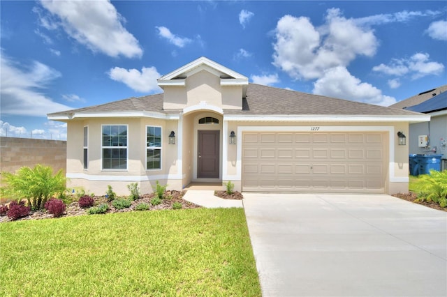 view of front of home with a garage, solar panels, and a front yard