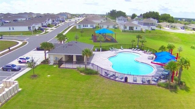 view of swimming pool with a patio and a lawn