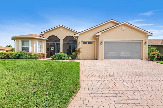 ranch-style home featuring a garage and a front lawn