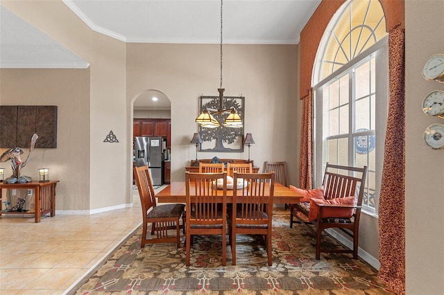 dining room with ornamental molding and tile patterned floors