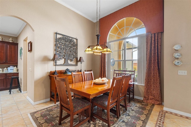 tiled dining space featuring crown molding