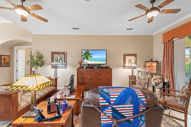 living room featuring crown molding and ceiling fan