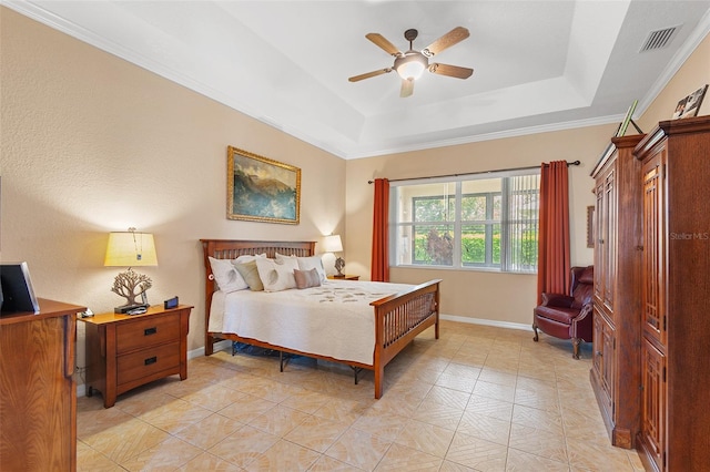 bedroom with crown molding, ceiling fan, and a raised ceiling