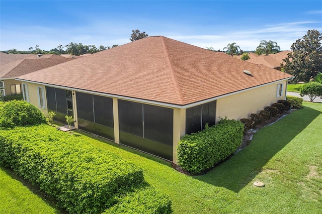 back of property featuring a yard and a sunroom